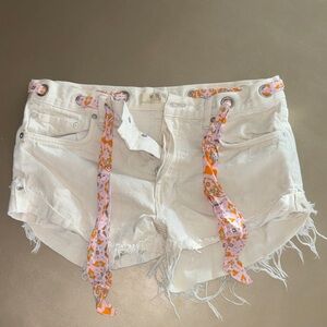 We The Free White Distressed Denim Shorts with Pink-Orange Tie Accents